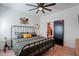 Bedroom with black metal frame bed, side tables, decorations, light colored wood floors, and a black sliding door at 291 N Washington St, Chandler, AZ 85225