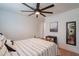 Cozy bedroom showcasing decorative mirror, patterned bedding, and a modern ceiling fan at 291 N Washington St, Chandler, AZ 85225