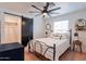 Bedroom with black metal frame bed, side tables, decorations, light colored wood floors, and a sliding door closet at 291 N Washington St, Chandler, AZ 85225