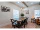 Elegant dining room featuring a rustic wooden table, stylish lighting, and charming decor at 291 N Washington St, Chandler, AZ 85225