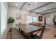 Dining area with farmhouse table, exposed beams, and open layout to living room at 291 N Washington St, Chandler, AZ 85225