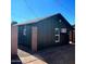 Exterior view of house with dark siding and black trim at 291 N Washington St, Chandler, AZ 85225