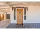 Inviting front entrance with a unique, rustic wooden door and decorative tile accents at 291 N Washington St, Chandler, AZ 85225