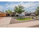 Well-maintained single-story home with charming landscaping and a spacious driveway and carport at 291 N Washington St, Chandler, AZ 85225