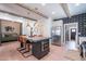 Eat-in kitchen featuring stainless steel appliances, modern black and white backsplash, and exposed beam ceilings at 291 N Washington St, Chandler, AZ 85225