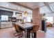 Spacious kitchen featuring stainless steel appliances, island with seating, and brick accent wall at 291 N Washington St, Chandler, AZ 85225