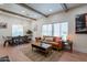 Spacious living room featuring exposed beam ceilings, light wood floors, and a large window at 291 N Washington St, Chandler, AZ 85225