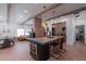 Bright living room with exposed beams, fireplace, and a large kitchen island with seating at 291 N Washington St, Chandler, AZ 85225