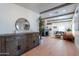 Open-concept living area with wood flooring, a fireplace, and seamless flow to dining area at 291 N Washington St, Chandler, AZ 85225