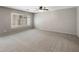A spacious bedroom is bright with a large window that has plantation shutters and neutral colored walls at 2929 E Binner Dr, Chandler, AZ 85225