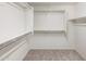 Bright walk-in closet featuring metal hanging rods, a shelf, and neutral carpeting at 2929 E Binner Dr, Chandler, AZ 85225