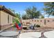 Outdoor space featuring a seating area around a fire pit, hardscape patio and landscape at 2994 E Sports Ct, Gilbert, AZ 85298