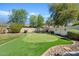 Lush backyard with a putting green, rock borders, and mature trees at 2994 E Sports Ct, Gilbert, AZ 85298