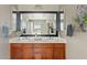 Bathroom featuring double sinks, dark wood cabinets, and a modern mirror at 2994 E Sports Ct, Gilbert, AZ 85298