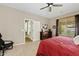 Bedroom featuring a window with blinds, access to the bathroom, and a ceiling fan at 2994 E Sports Ct, Gilbert, AZ 85298