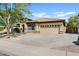 Charming single-story home with a tile roof, tan stucco, and a spacious two-car garage at 2994 E Sports Ct, Gilbert, AZ 85298