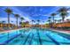 Resort-style community pool surrounded by palm trees and lounge chairs at 2994 E Sports Ct, Gilbert, AZ 85298