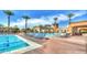 Beautiful community pool and lounge area with resort-style seating and swaying palm trees on a sunny day at 2994 E Sports Ct, Gilbert, AZ 85298