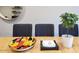 Dining area with seating for three, decorative fruit bowl, and modern plant at 3041 S Country Club Way, Tempe, AZ 85282