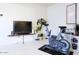 Exercise area with spin bike, flat screen TV, storage, and accent wall decor at 3041 S Country Club Way, Tempe, AZ 85282