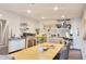 Spacious kitchen featuring stainless steel appliances and a large wooden table at 3041 S Country Club Way, Tempe, AZ 85282