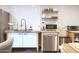 Modern kitchen with stainless steel appliances, white subway tiles, and open shelving at 3041 S Country Club Way, Tempe, AZ 85282