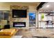 Inviting living room featuring a stone-accented fireplace and a large-screen TV at 3041 S Country Club Way, Tempe, AZ 85282