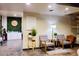 Comfortable sitting area with stylish chairs, opening into a space with white cabinets and a clock at 3041 S Country Club Way, Tempe, AZ 85282