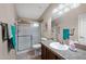 This well-lit bathroom features tile floors, a shower with glass doors, and a single sink vanity at 3301 S Goldfield Rd # 3005, Apache Junction, AZ 85119