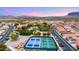 Aerial view of a vibrant community featuring a pool, tennis courts, and mountain views at 3301 S Goldfield Rd # 3005, Apache Junction, AZ 85119