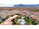 Aerial view of a luxurious community showcasing a pool, palm trees, and lush landscaping at 3301 S Goldfield Rd # 3005, Apache Junction, AZ 85119