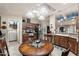 Well lit kitchen area featuring tile flooring, light countertops, stainless steel appliances, and a round kitchen table at 3301 S Goldfield Rd # 3005, Apache Junction, AZ 85119