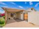 This covered patio has a door to the house and an adjacent gate with a brick floor at 332 N 25Th St, Mesa, AZ 85213