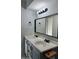 Bathroom vanity with double sinks, modern fixtures, and a large mirror with accent lighting at 332 N 25Th St, Mesa, AZ 85213