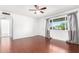 This bedroom features hardwood floors, a ceiling fan, and a window with curtains at 332 N 25Th St, Mesa, AZ 85213