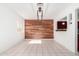 Bright dining room with wood accent wall, contemporary lighting, and tile flooring at 332 N 25Th St, Mesa, AZ 85213