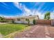 Well-maintained home with manicured lawn, desert landscaping, and gated driveway at 332 N 25Th St, Mesa, AZ 85213