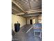 Large two car garage with lights, corrugated metal ceiling and concrete floors at 332 N 25Th St, Mesa, AZ 85213