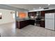 Bright kitchen featuring stainless steel appliances, granite countertops, dark wood cabinets, and tile floors at 332 N 25Th St, Mesa, AZ 85213