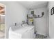 This laundry room has a tile floor and a Whirlpool washing machine and dryer at 332 N 25Th St, Mesa, AZ 85213