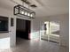 Open-concept living space with tiled floor, modern light fixture, and access to the backyard at 332 N 25Th St, Mesa, AZ 85213