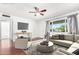 Bright living room boasts hardwood floors, a ceiling fan, and natural light from a large window at 332 N 25Th St, Mesa, AZ 85213