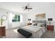 Calm main bedroom featuring neutral walls, a ceiling fan, and a large sunny window at 332 N 25Th St, Mesa, AZ 85213