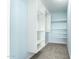 A walk-in closet with built-in shelving and carpeted floor at 332 N 25Th St, Mesa, AZ 85213