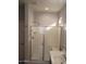 Bright bathroom features a sink vanity and glass enclosed shower with a seat at 37180 W Mondragone Ln, Maricopa, AZ 85138