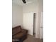 A bedroom closet with sliding doors, revealing a shelf and pole for ample storage at 37180 W Mondragone Ln, Maricopa, AZ 85138