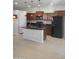 Updated kitchen with granite countertops, dark appliances, rich cabinetry and an island providing counter space and style at 37180 W Mondragone Ln, Maricopa, AZ 85138