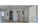 Open living area with tile flooring, neutral walls, and arched doorways at 37180 W Mondragone Ln, Maricopa, AZ 85138