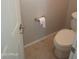 Bathroom featuring a toilet, toilet paper holder and base trim at 37180 W Mondragone Ln, Maricopa, AZ 85138