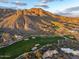 Expansive aerial view of a desert property on a golf course with stunning mountain views in the background at 42171 N Saguaro Forest Dr, Scottsdale, AZ 85262